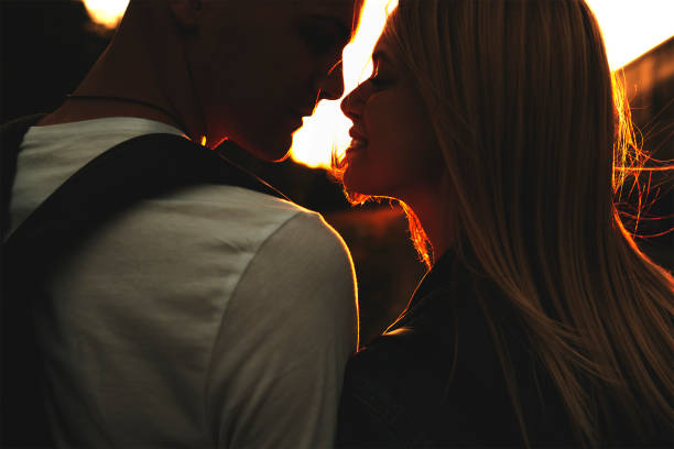 istock Adorable couple standing together at sunset 990876666