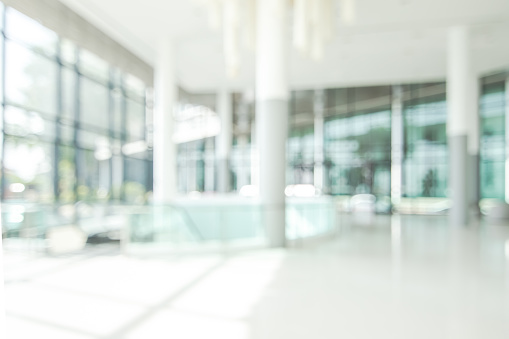 Hotel lobby blur background banquet hall interior view or blurry luxurious foyer of empty atrium space, office entrance doors, glass wall and window