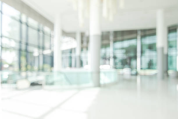 Hotel lobby blur background banquet hall interior view of luxurious foyer of empty atrium space and entrance doors and glass wall Hotel lobby blur background banquet hall interior view or blurry luxurious foyer of empty atrium space, office entrance doors, glass wall and window building entrance photos stock pictures, royalty-free photos & images