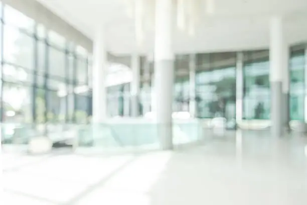 Hotel lobby blur background banquet hall interior view or blurry luxurious foyer of empty atrium space, office entrance doors, glass wall and window