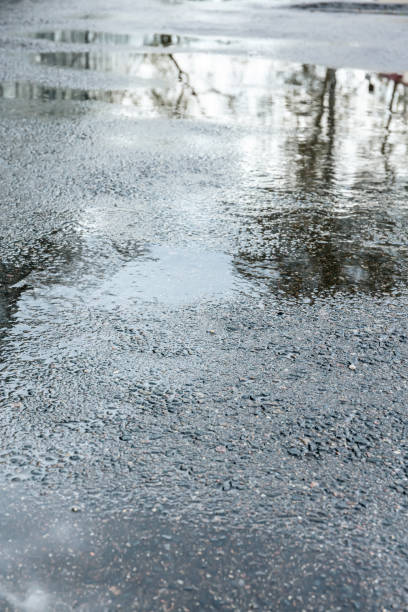 istock city road wet after rain 990880280