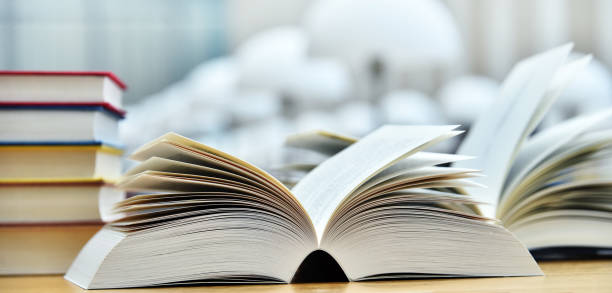istock Books lying on the table in the public library 990888358