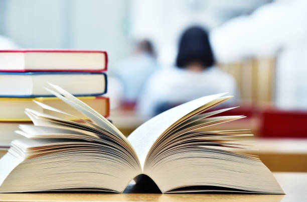 istock Books lying on the table in the public library 990888440
