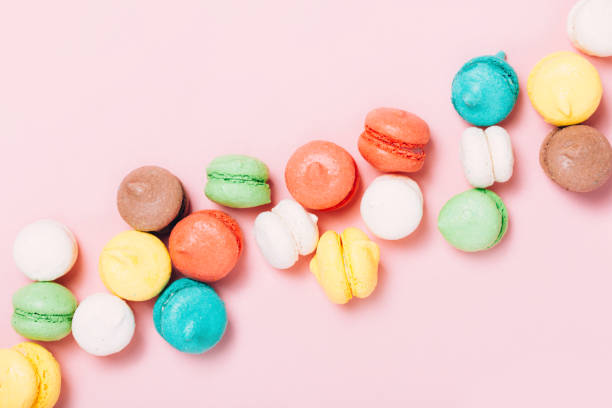 istock Pile of colorful macarons on pink background 990889930