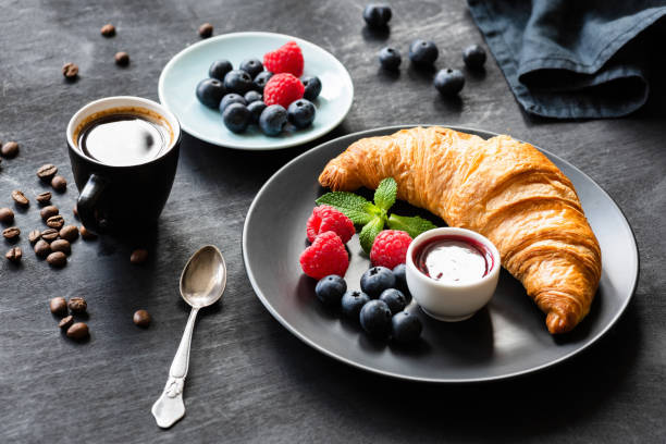 istock Croissant, fresh berries, jam and cup of coffee espresso 990893908