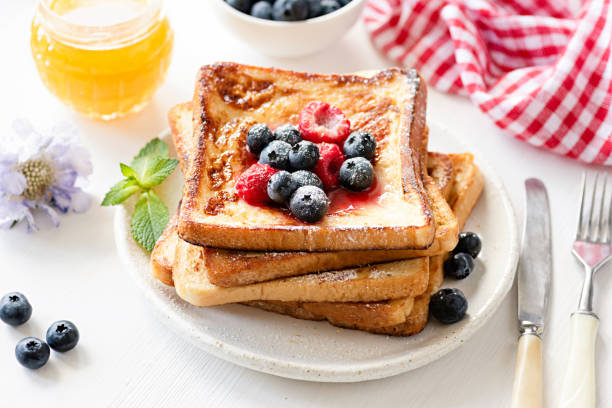 istock French toast with berries on white plate 990893950