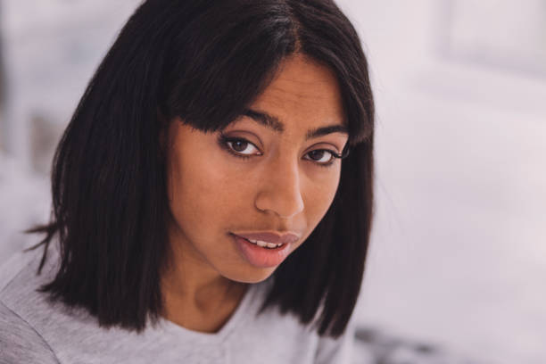 istock Close up of young brunette that posing on camera 990897706