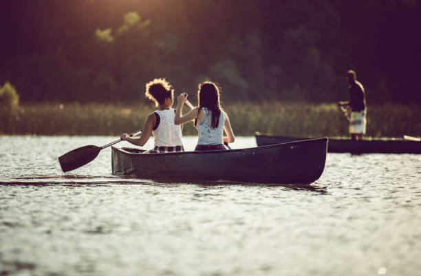 istock Small Group of Friends Canoeing on the Lake 990897926