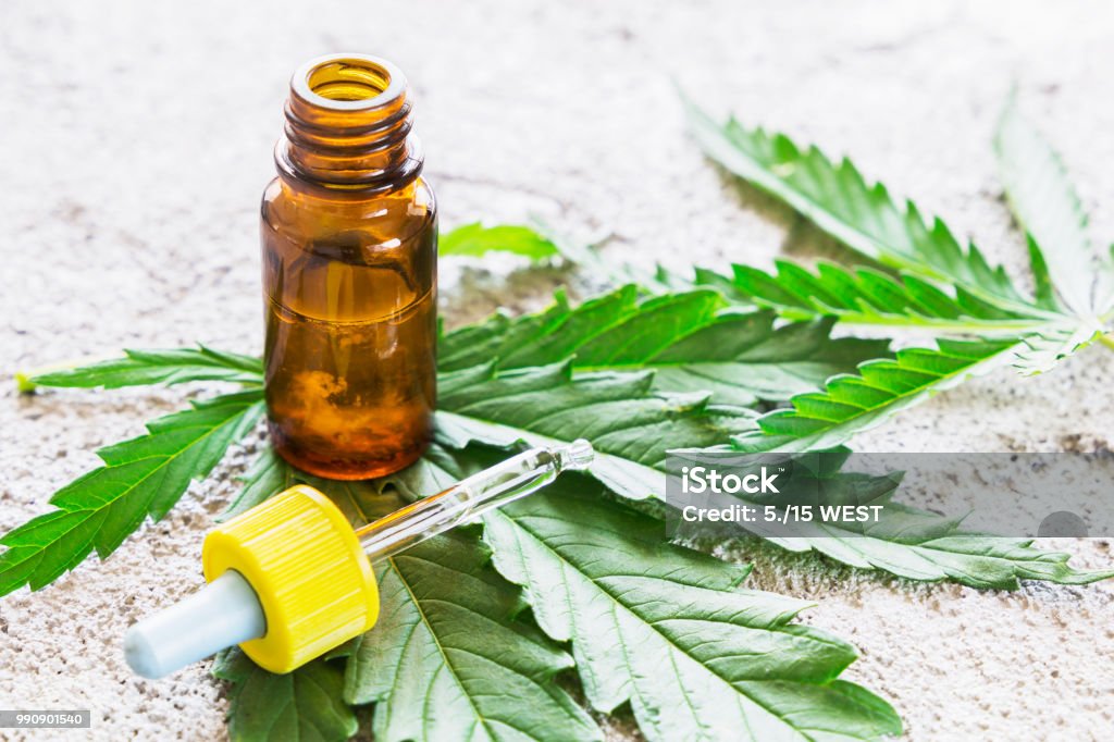 Cannabis - Marijuana oil extracts in jars and leaves for treatment. Crude Oil Stock Photo