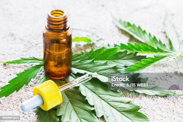 Cannabis Marijuana Oil Extracts In Jars And Leaves For Treatment Stock Photo - Download Image Now