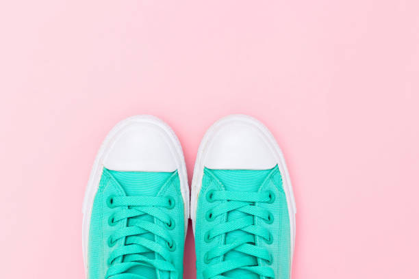 Sneakers mint color on a pink background. Flat lay