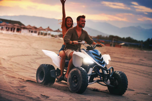 istock Riding a quad bike on a beach. 990901866