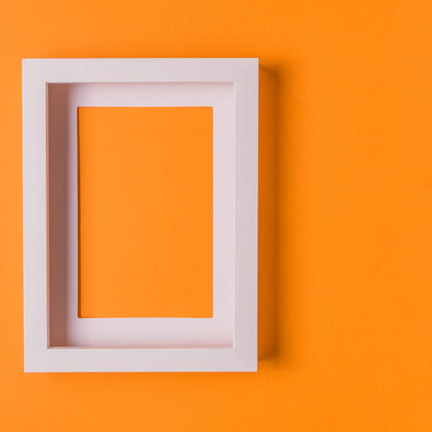 istock Abstract minimalism colofrul paper background with empty picture frame. 990902786