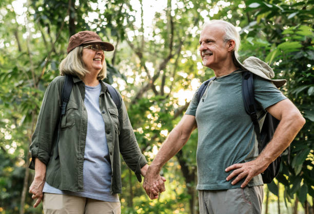 istock Elderly couple holding hands in the forest 990903084