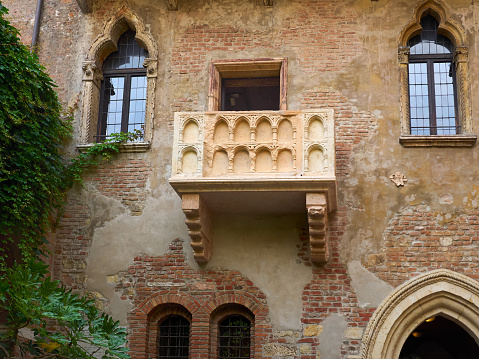 Barcelona, Spain, - May 23, 2022. Senior Couple having breakfast on typical balcony of a historical apartment.