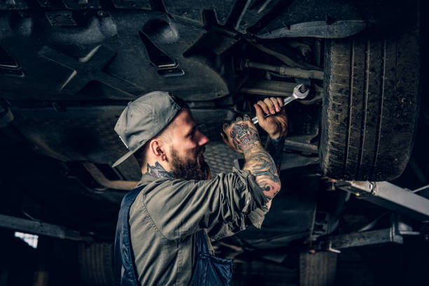 istock Mechanic balancing car's wheel in a workshop. 990916892