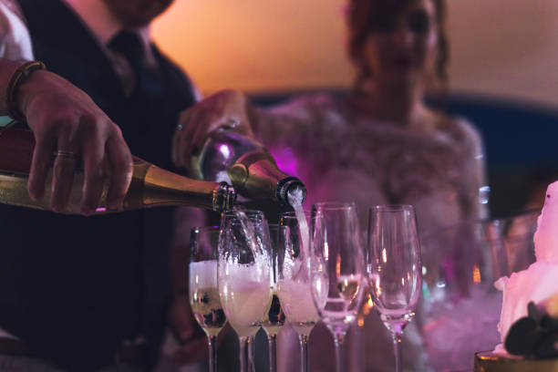 istock Bride and groom are pouring champagne 990917776