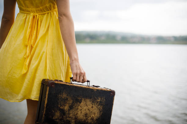 Young woman with suitcase on the pier.