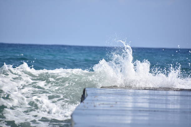 Waves crashing against the pier