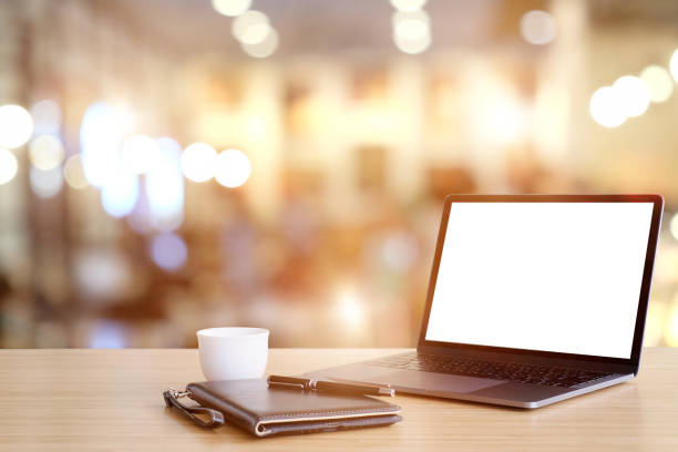 istock Mockup laptop Comfortable work table in cafe. Blank screen for graphic montage. 990957846