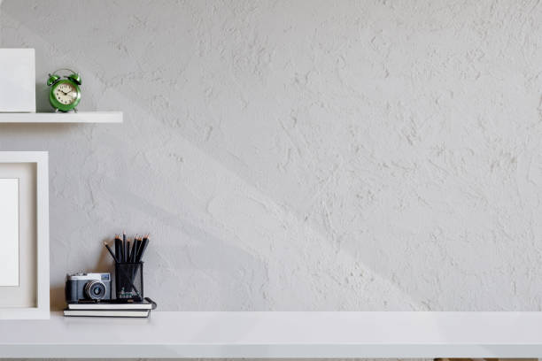 istock Minimal workspace with camera and poster on desk. 990957902