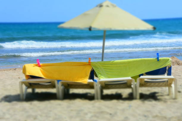 istock Towels and parasols on the beach 990965106