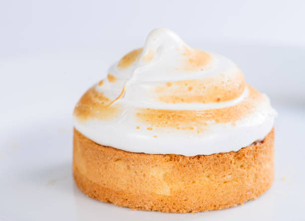 istock Appetizing sweet dessert. White glaze cupcake with cream on ligh 990967238