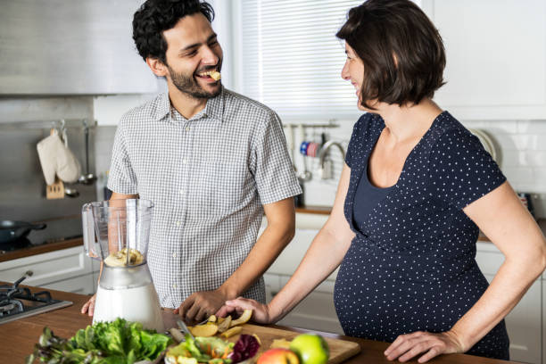 istock Caucasian couple making fresh smoothie 990972852