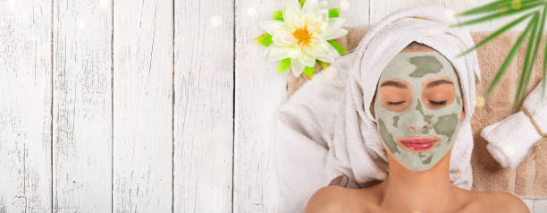 Young healthy woman with face mask Young healthy woman in spa making treatments and face mask. facial mask beauty product stock pictures, royalty-free photos & images