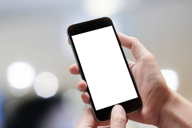 istock Woman hand holding smartphone with blur bokeh. Blank screen mobile phone for graphic display montage 991005016