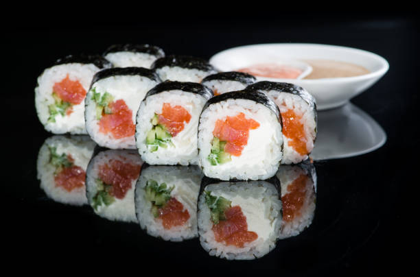 istock Japanese cuisine. Appetizing maki sushi rolls with rice, salmon, 991006280