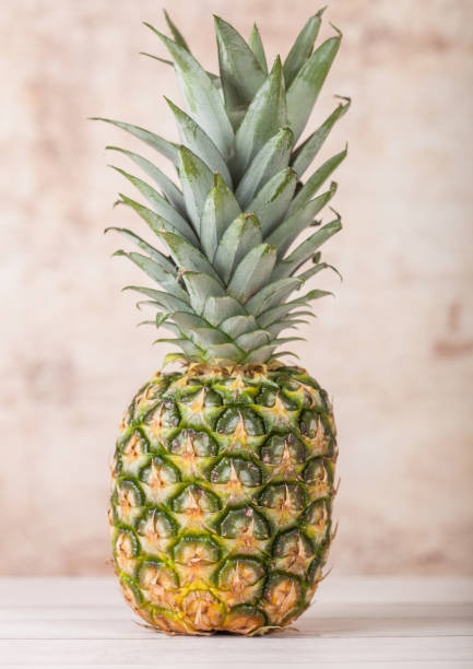 istock Fresh organic raw pineapple fruit on wood 991007524