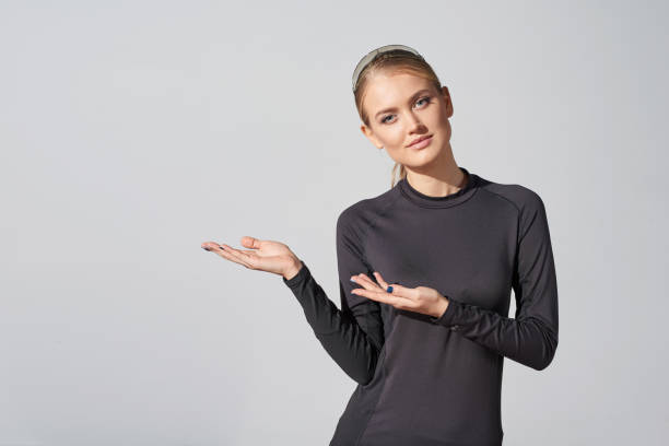 Woman in black shirt showing blank copy space in side