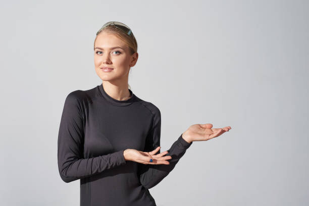 istock Woman in black shirt showing blank copy space in side 991013310
