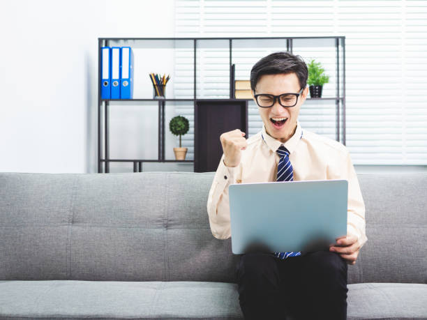 istock Young asian businessman smile successful sitting on sofa in office. 991015042