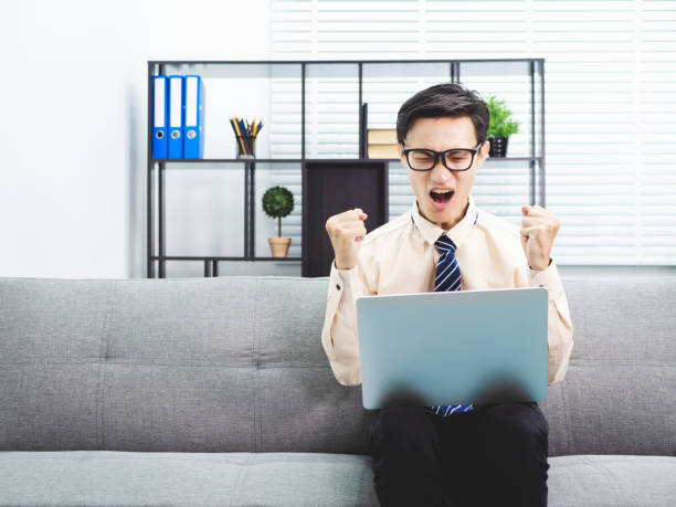 istock Young asian businessman smile successful sitting on sofa in office. 991015144