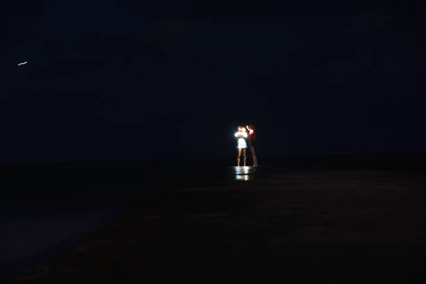 istock People walk on the dock at night- Long exposure 991017416