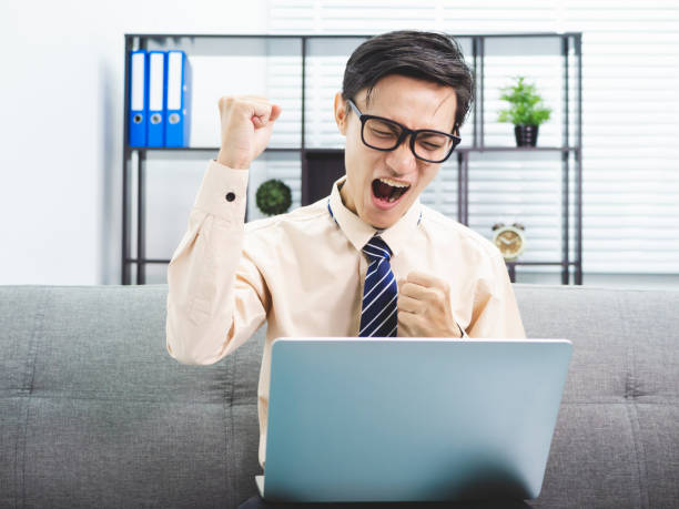 istock Young asian businessman smile successful sitting on sofa in office. 991023078