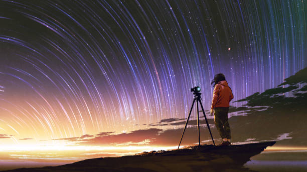 istock man taking picture of sunrise sky 991047850