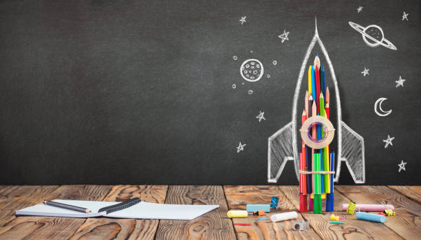 istock Back to School Concept with Hand Drawn Rocket on Blackboard 991053164