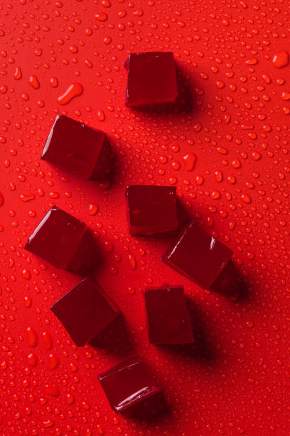 istock top view of candies on red surface with water drops 991058720