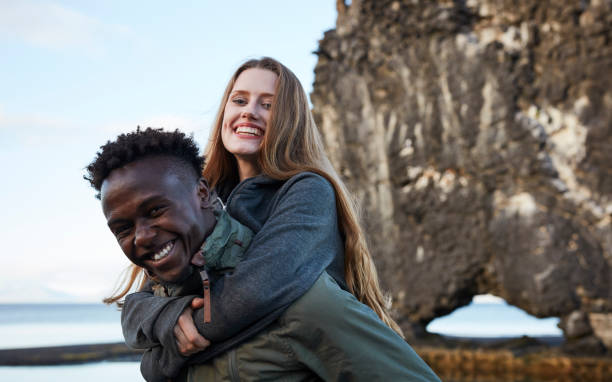 istock Multi ethnic couple having fun on the black beach 991062542