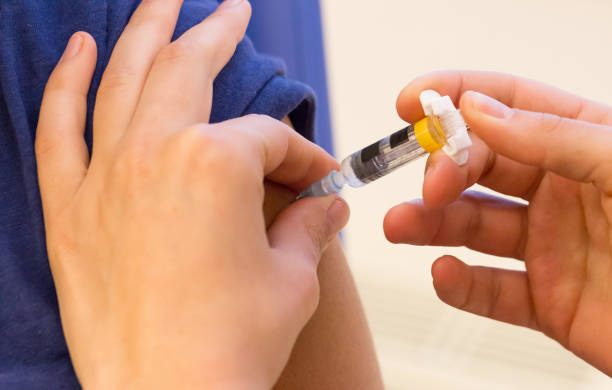 istock Doctor vaccinating a young woman 991063160