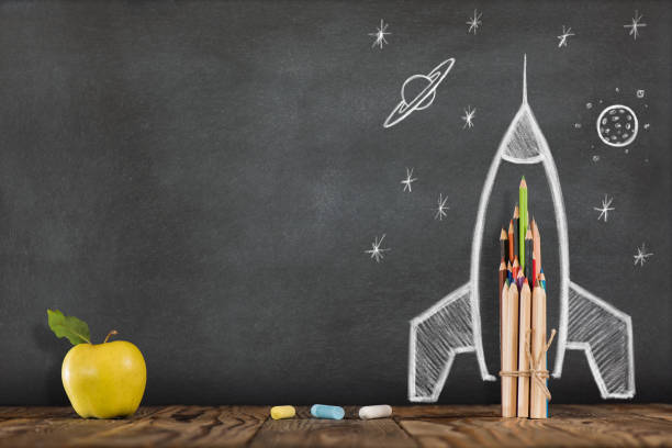 istock Back to School Concept with Hand Drawn Rocket on Blackboard 991067338