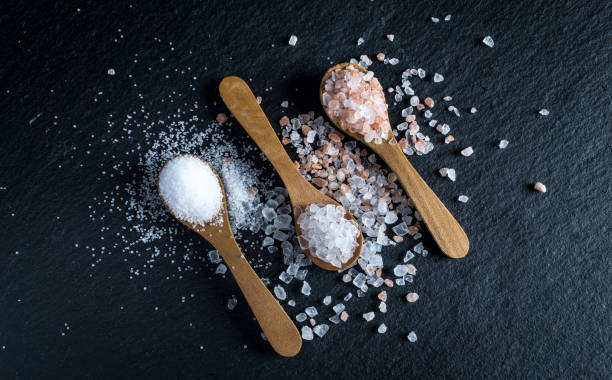 istock Different types of salt. Top view on three wooden spoons 991072850