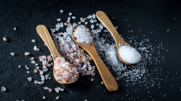 istock Different types of salt. Top view on three wooden spoons 991073180