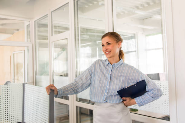 istock Smiling woman with clipboard in office 991077710