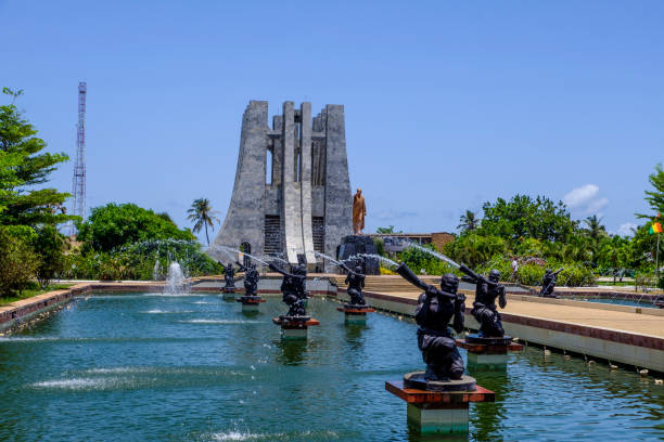 Kwame Nkrumah Memorial Park and fountains Accra,Ghana - April 11 2018: Looking through water fountains in Kwame Nkrumah Memorial Park to the marble Mausoleum and gold statue to the Ghanaian president ghana photos stock pictures, royalty-free photos & images