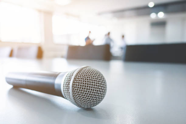 istock Closeup view microphone on table in meeting room with blurred background 991078560