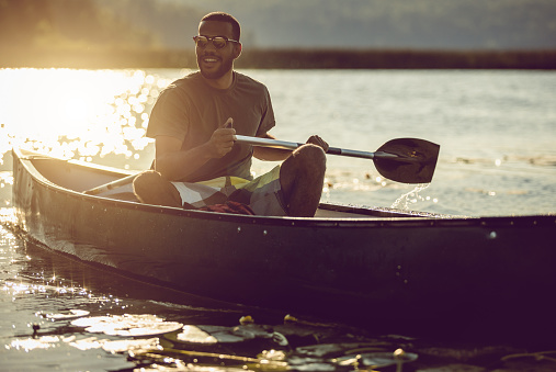 Young Man Canoeing on the Lake